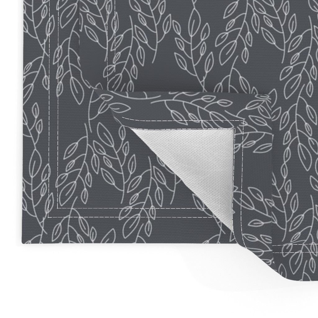 Close up of two Placemats stacked on top of eachother and the top left bottom corner is flipped up showing the hem and unprinted back