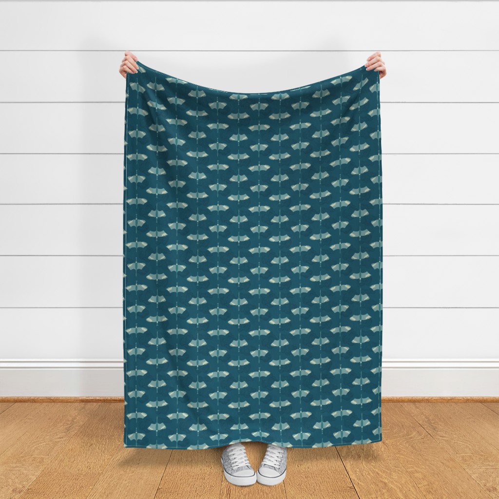 Throw blanket held up in front of a white shiplap wall