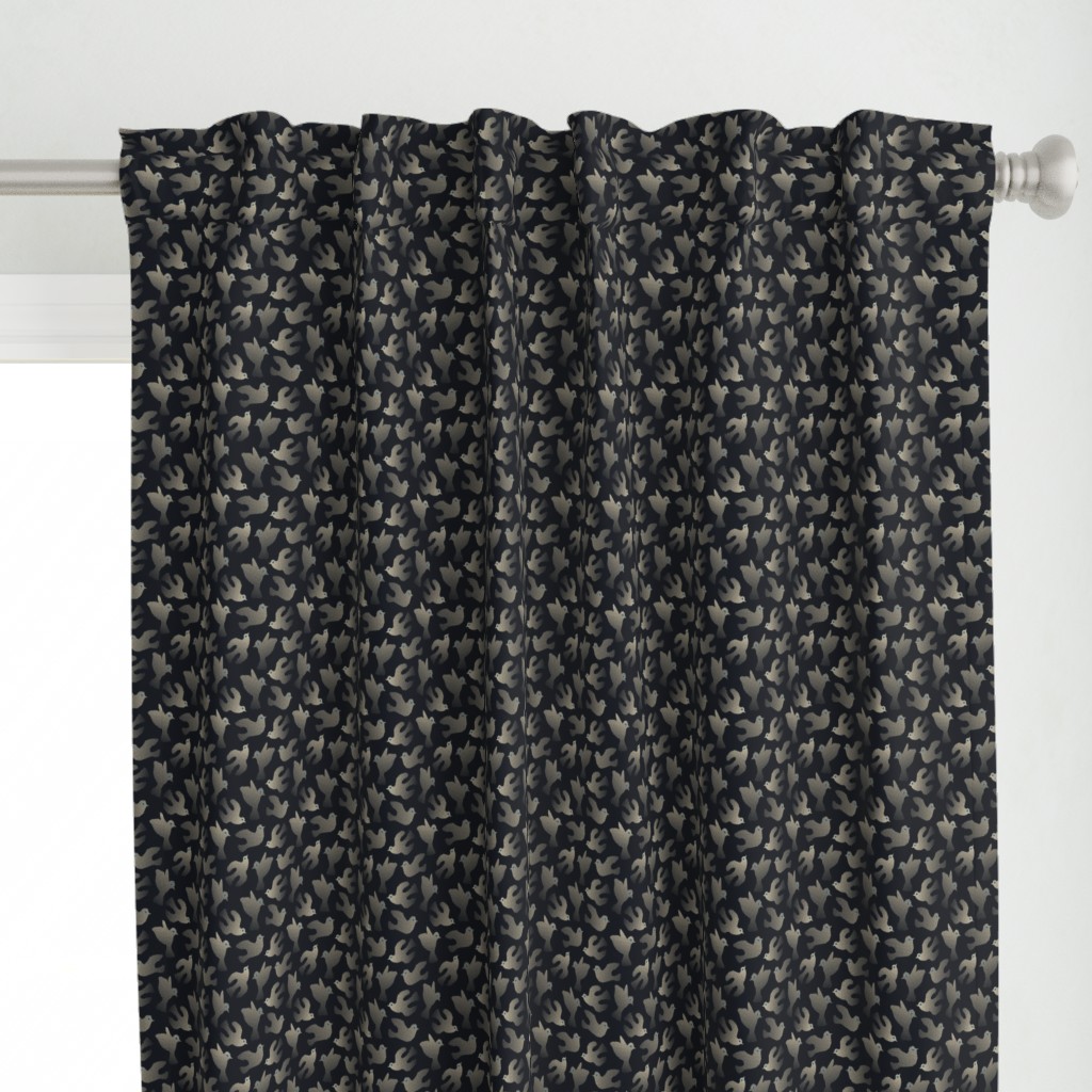 Close up of a Curtain panel hanging from a silver curtain rod in front of a window