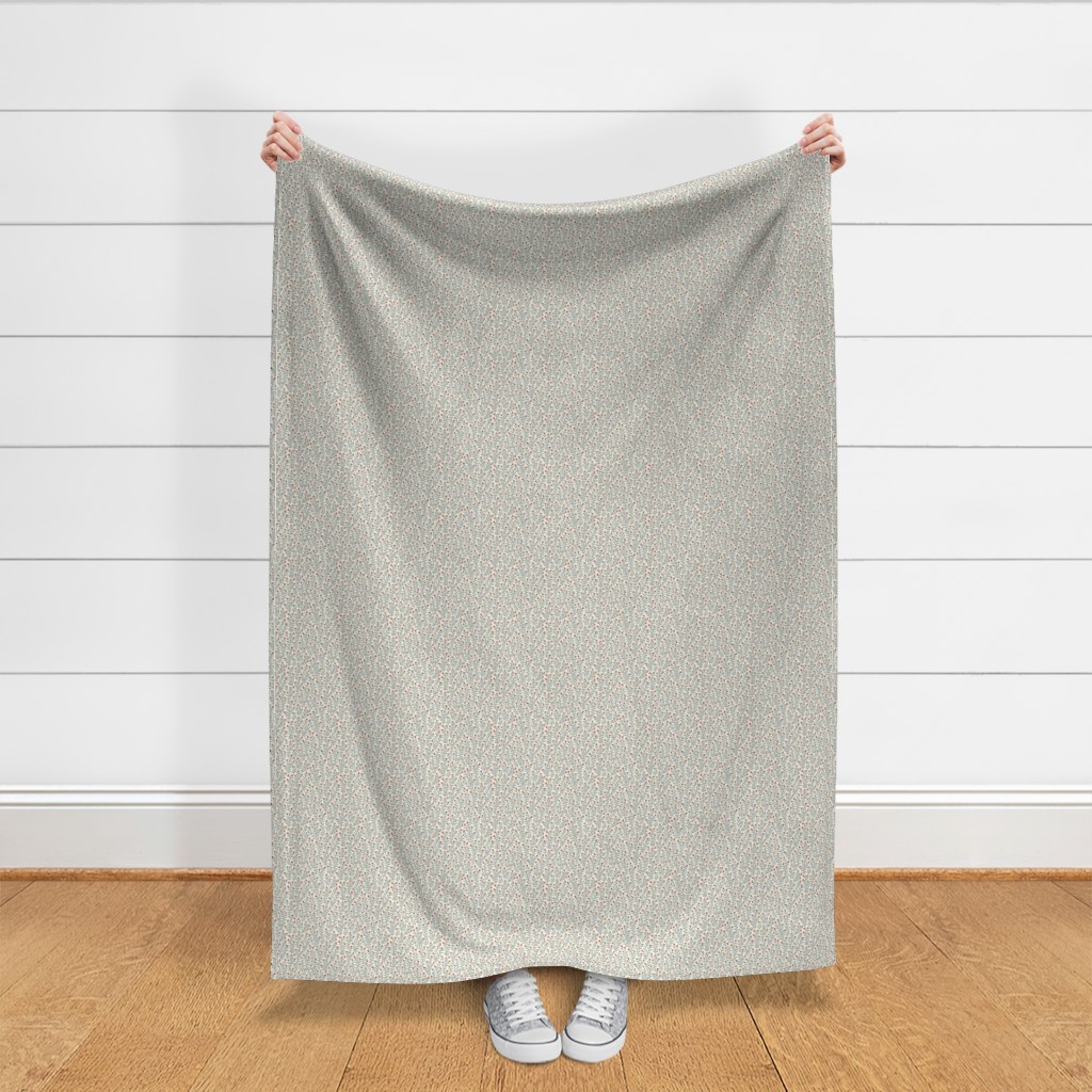 Throw blanket held up in front of a white shiplap wall