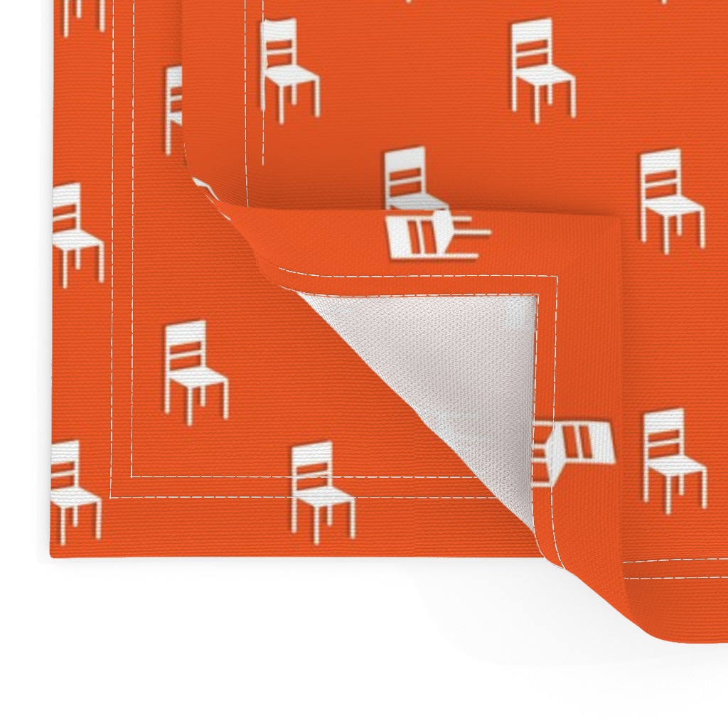 Close up of two Placemats stacked on top of eachother and the top left bottom corner is flipped up showing the hem and unprinted back
