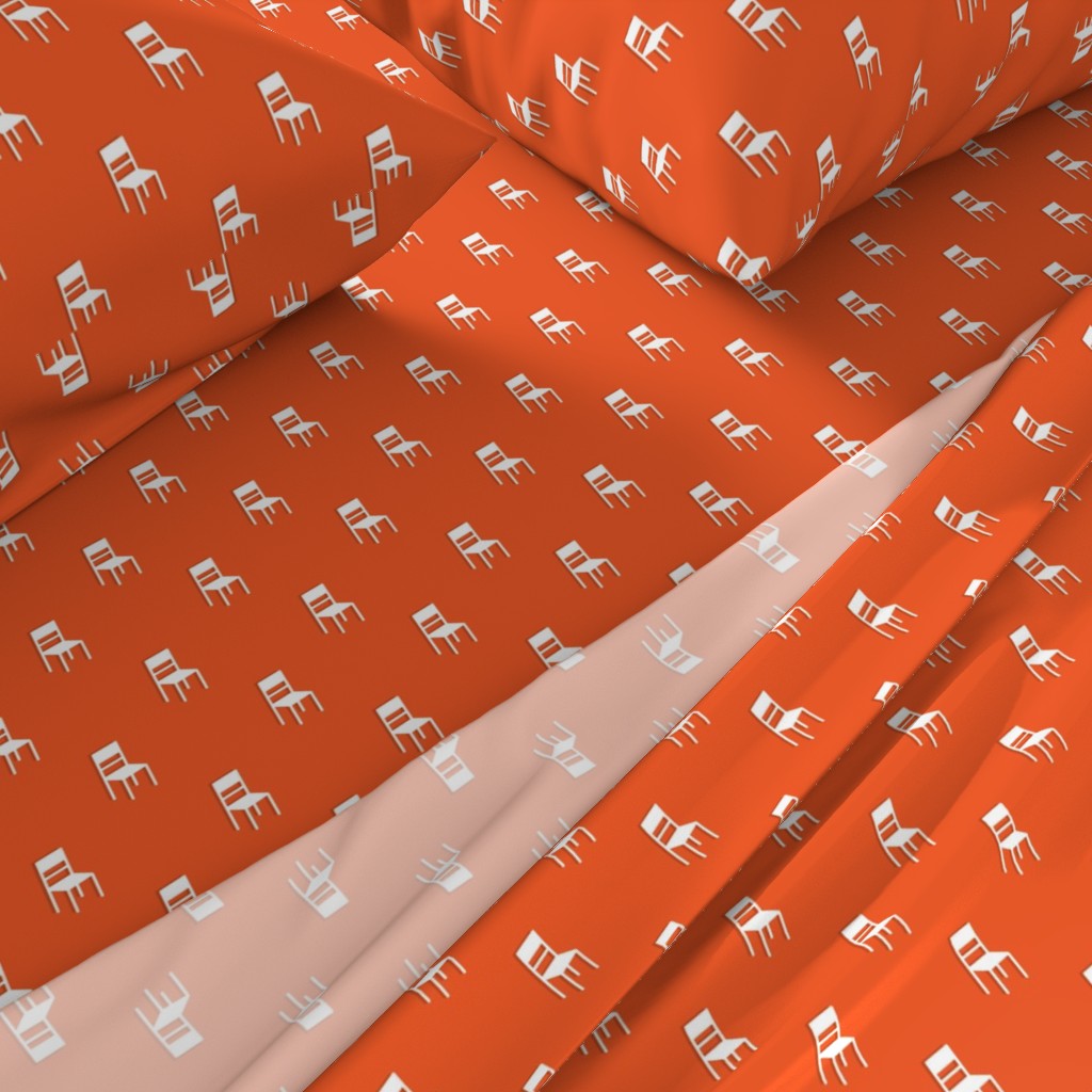 A close-up angled view of a bed with sheets and pillowcases