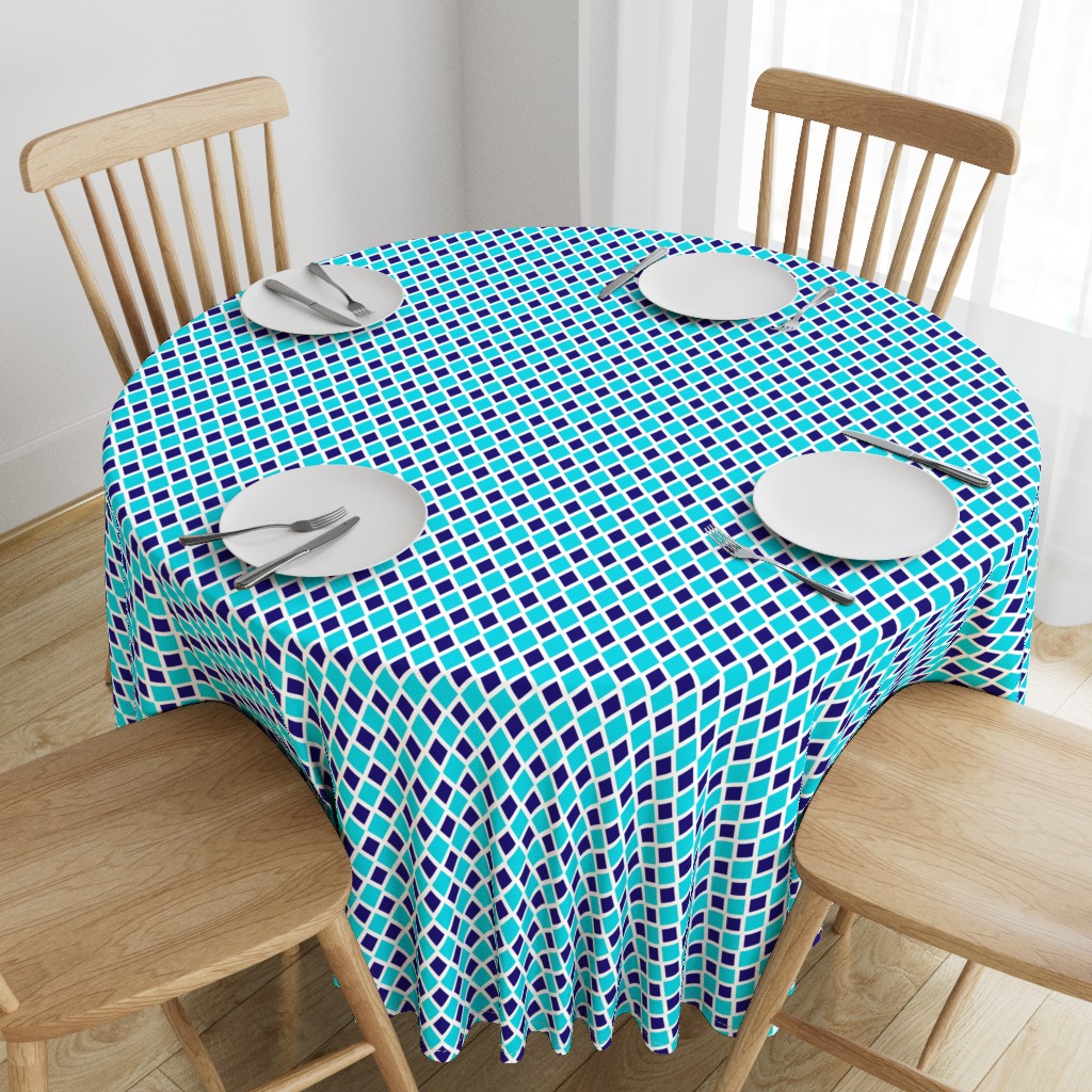 Top down angeled view of a wooden table with a 90 inch Round Tablecloth and four place settings arranged on top