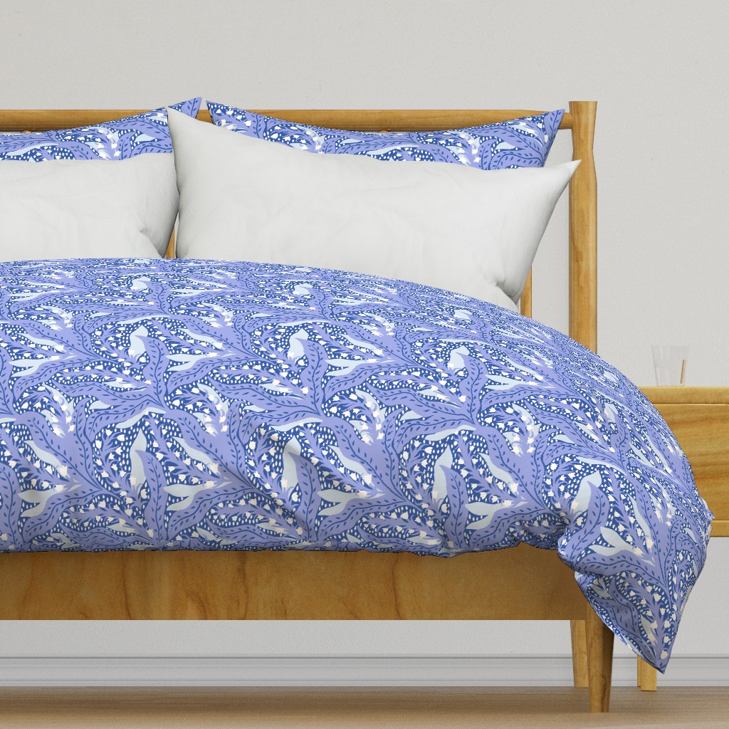 Light colored wooden bed frame with a duvet cover