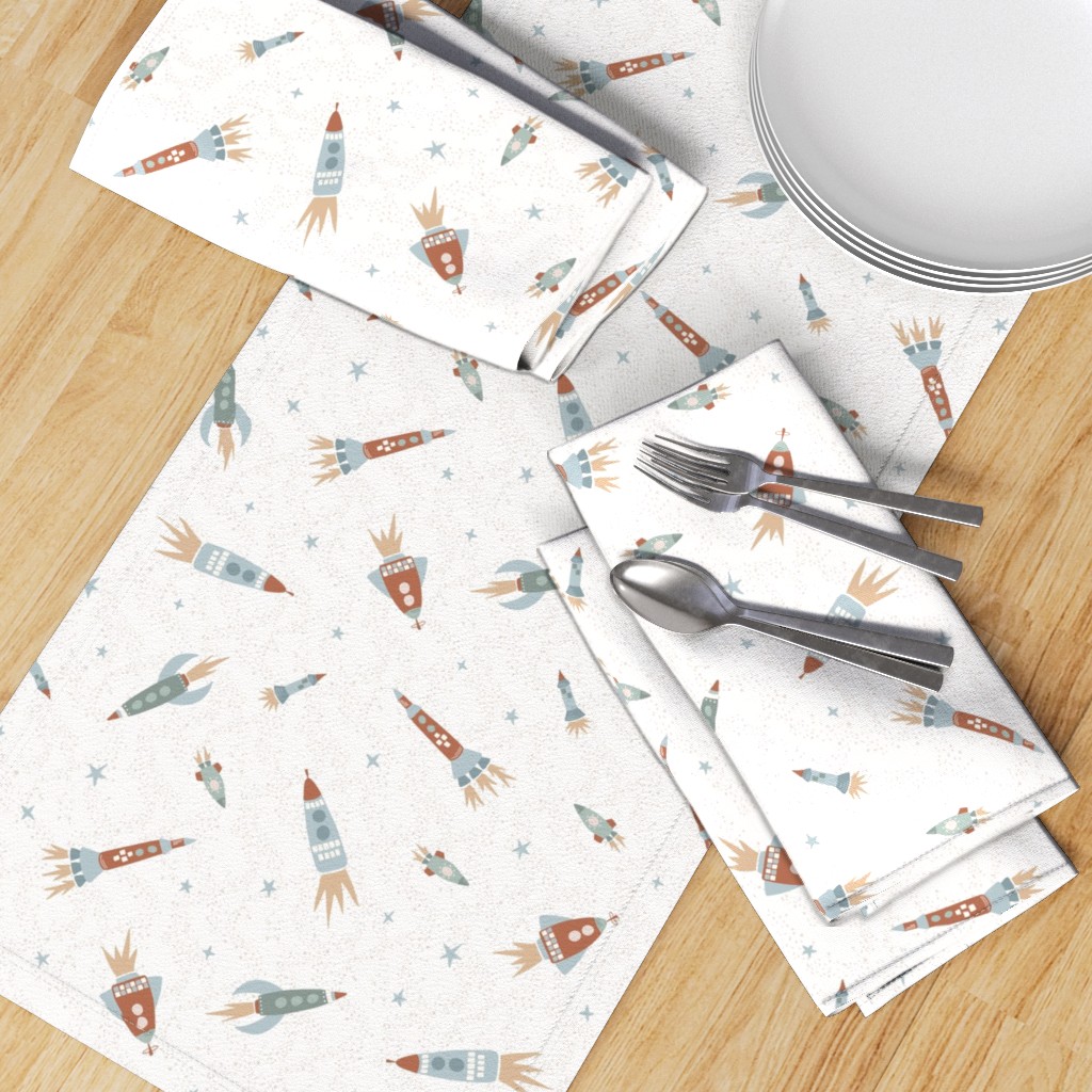 Top down table with a Table Runner placed diagonally with a set of Dinner Napkins, plates and silverware on top