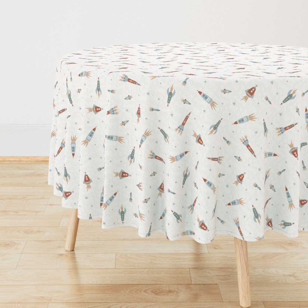 Side view of a circular wooden table with a Tablecloth draped over it, sitting on top of light wood floors