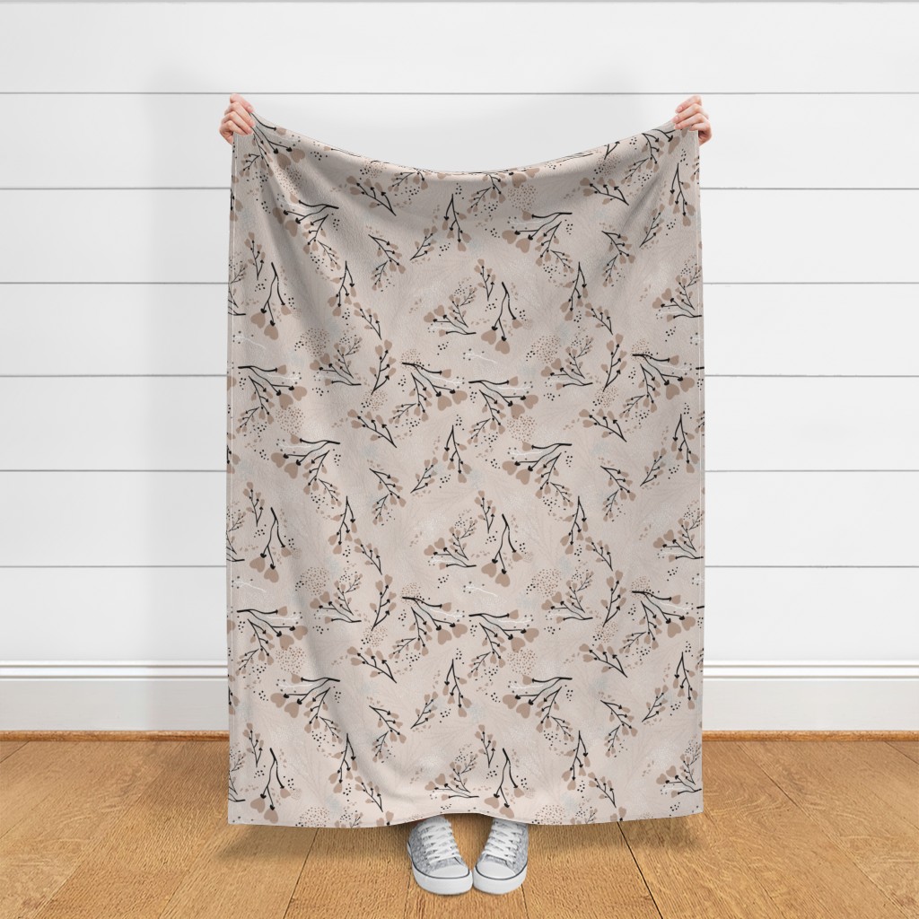 Throw blanket held up in front of a white shiplap wall