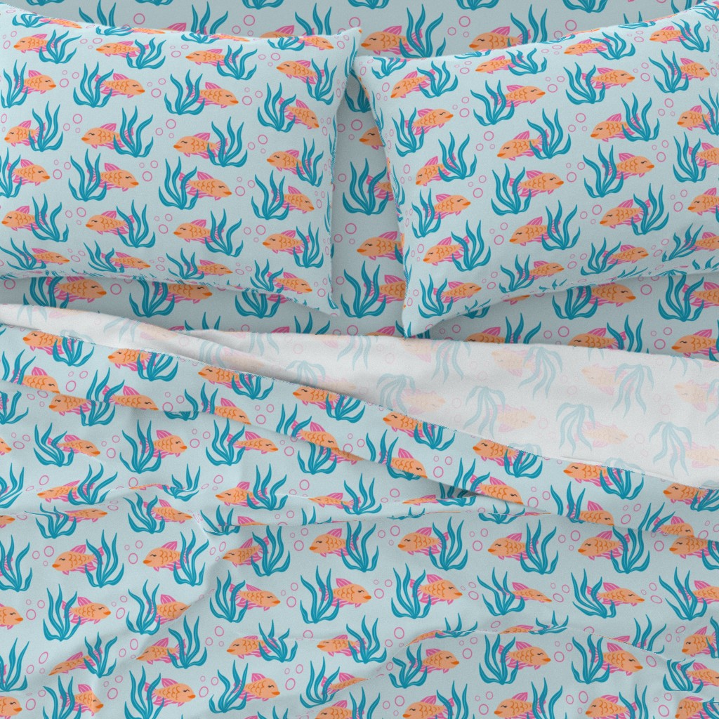 A close-up top down view of a bed with pillowcases and the top sheet pulled down slightly