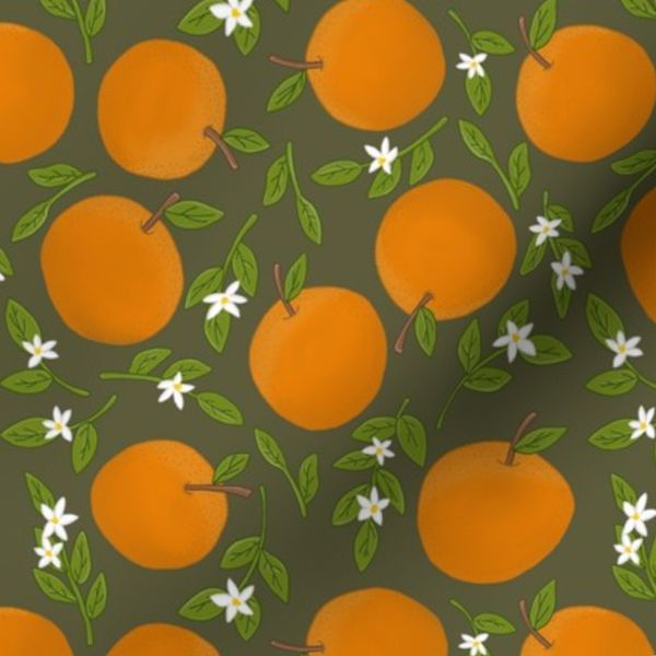 Oranges and blossom leaves on dark green