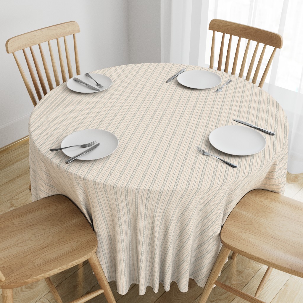 Top down angeled view of a wooden table with a 90 inch Round Tablecloth and four place settings arranged on top