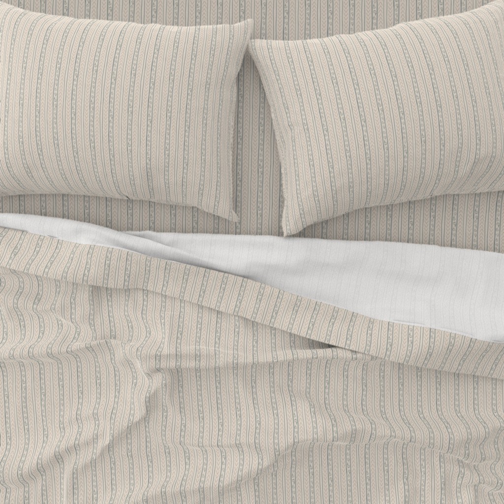 A close-up top down view of a bed with pillowcases and the top sheet pulled down slightly