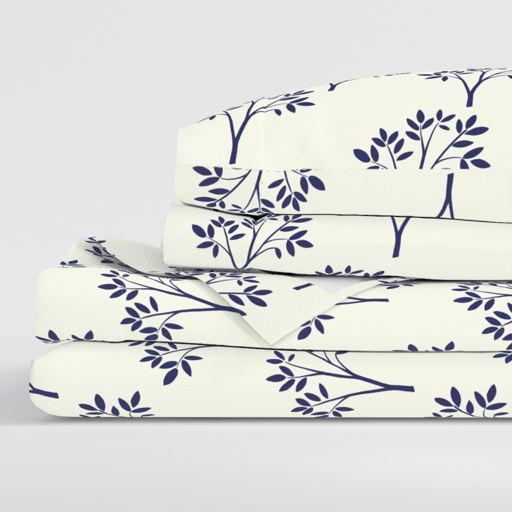 Side view of a folded stack of sheets with two pillowcases