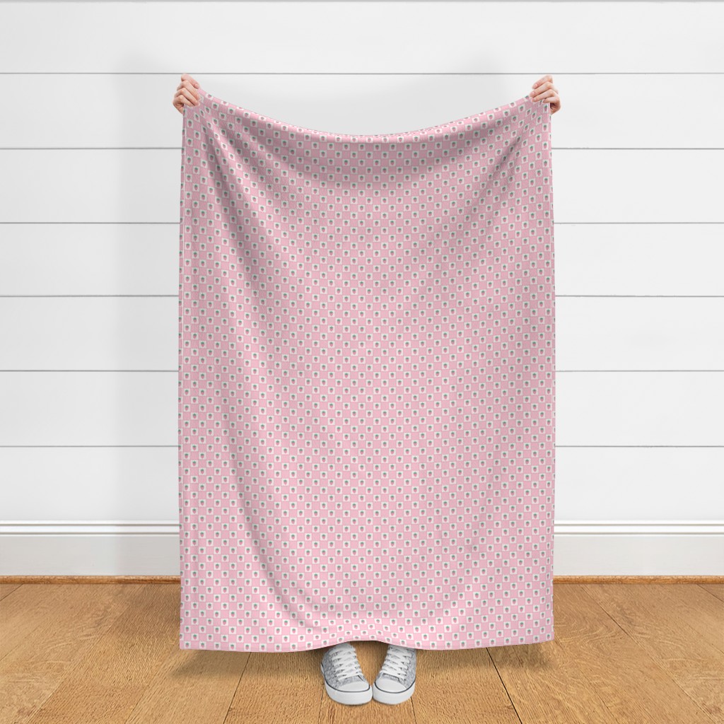Throw blanket held up in front of a white shiplap wall