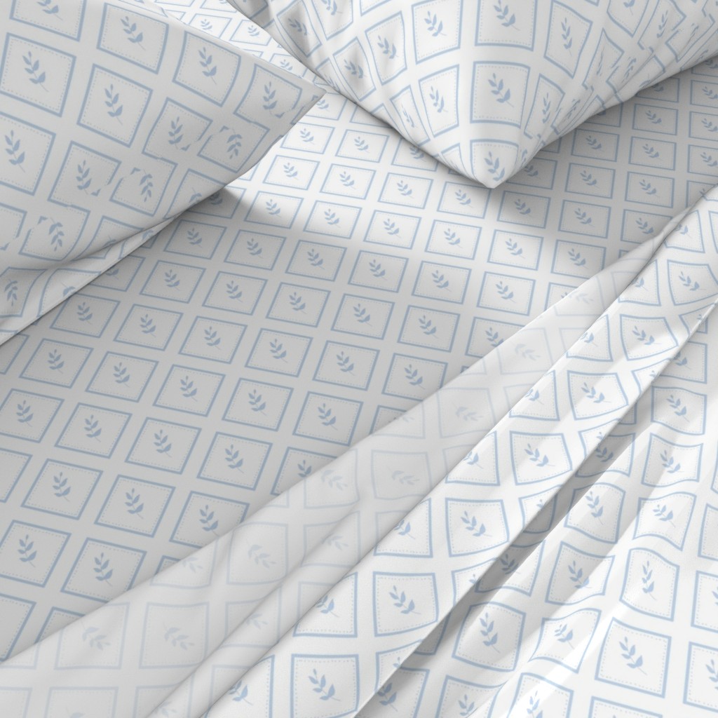 A close-up angled view of a bed with sheets and pillowcases