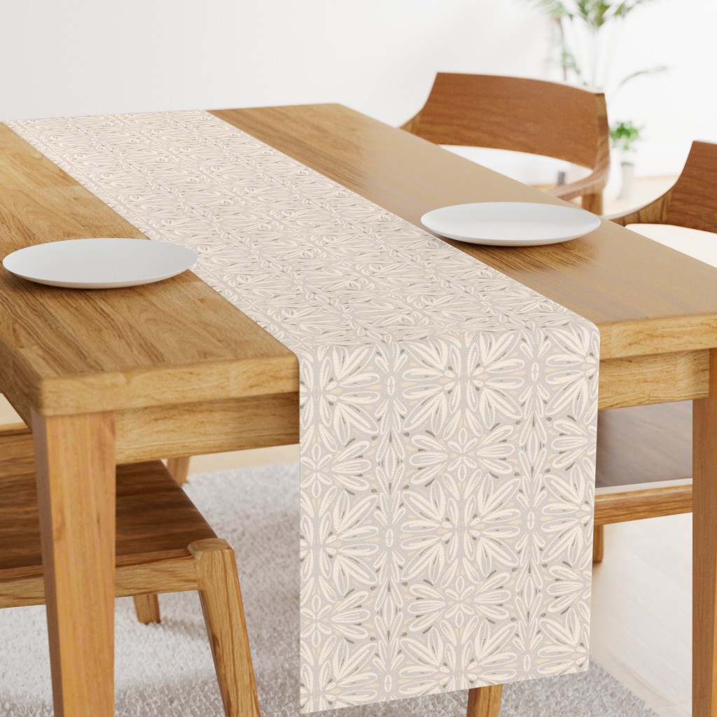 Angled light wood table with a 108 inch long Table Runner in the middle and two plates