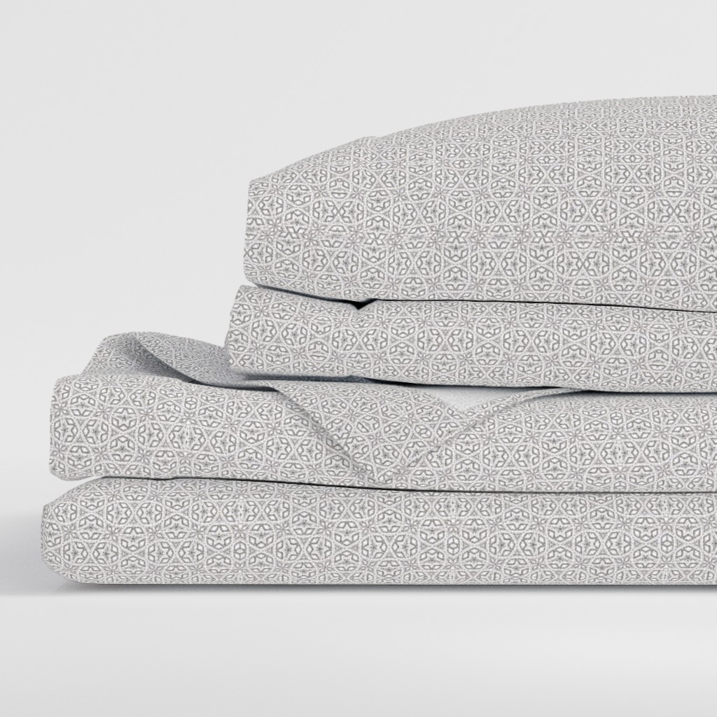 Side view of a folded stack of sheets with two pillowcases