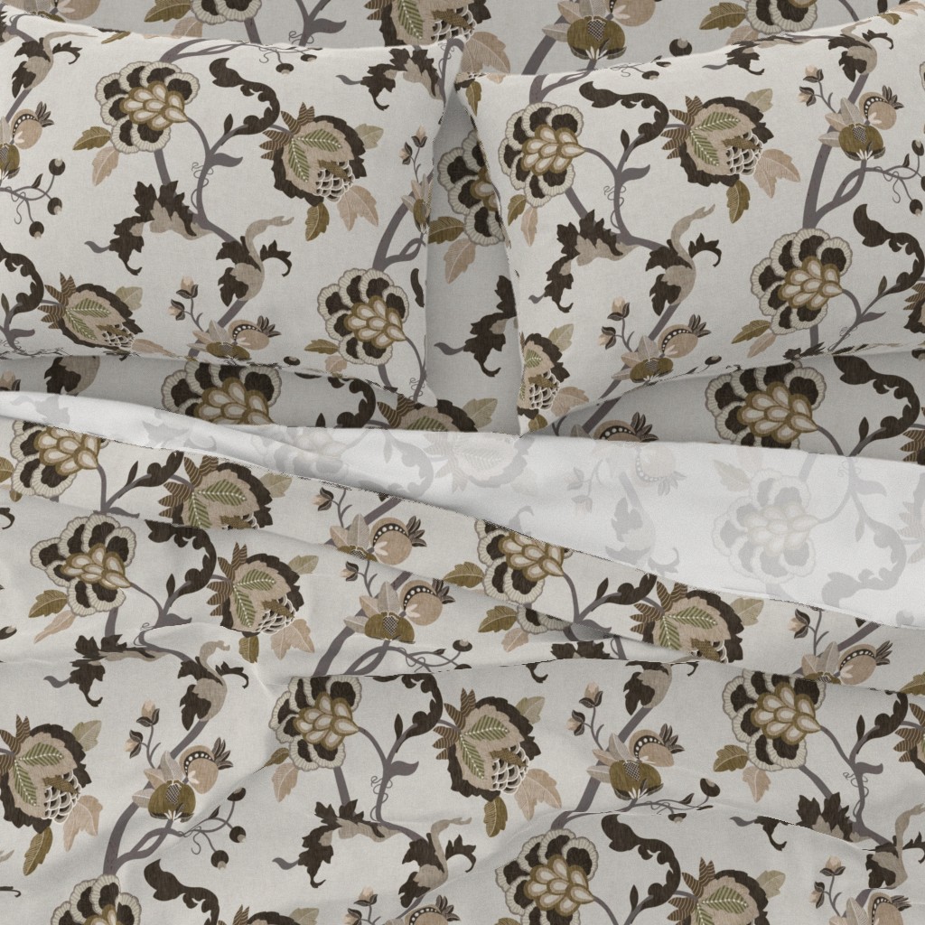 A close-up top down view of a bed with pillowcases and the top sheet pulled down slightly