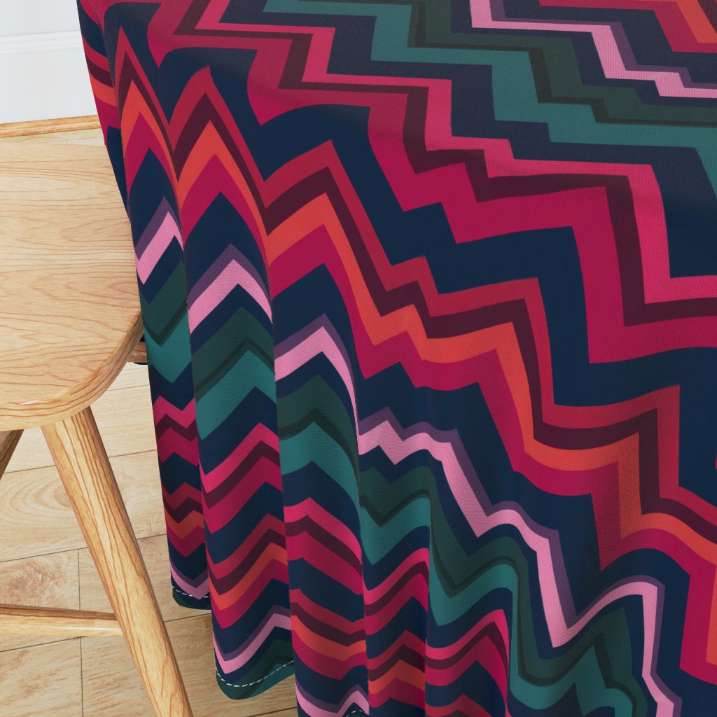 Angeled side view of a round table with wooden chair in the foreground and a 90 inch Tablecloth draped over the edge showing the sewn hem around the edge