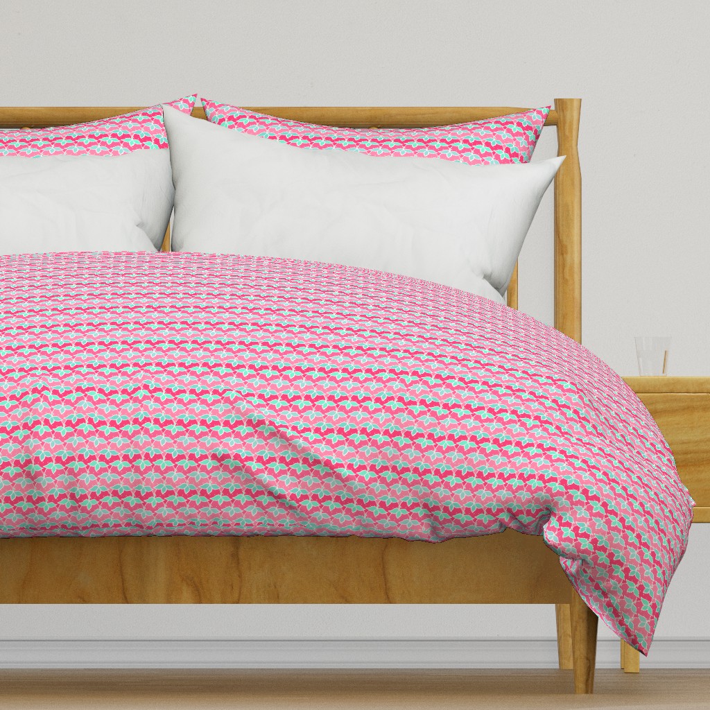 Light colored wooden bed frame with a duvet cover