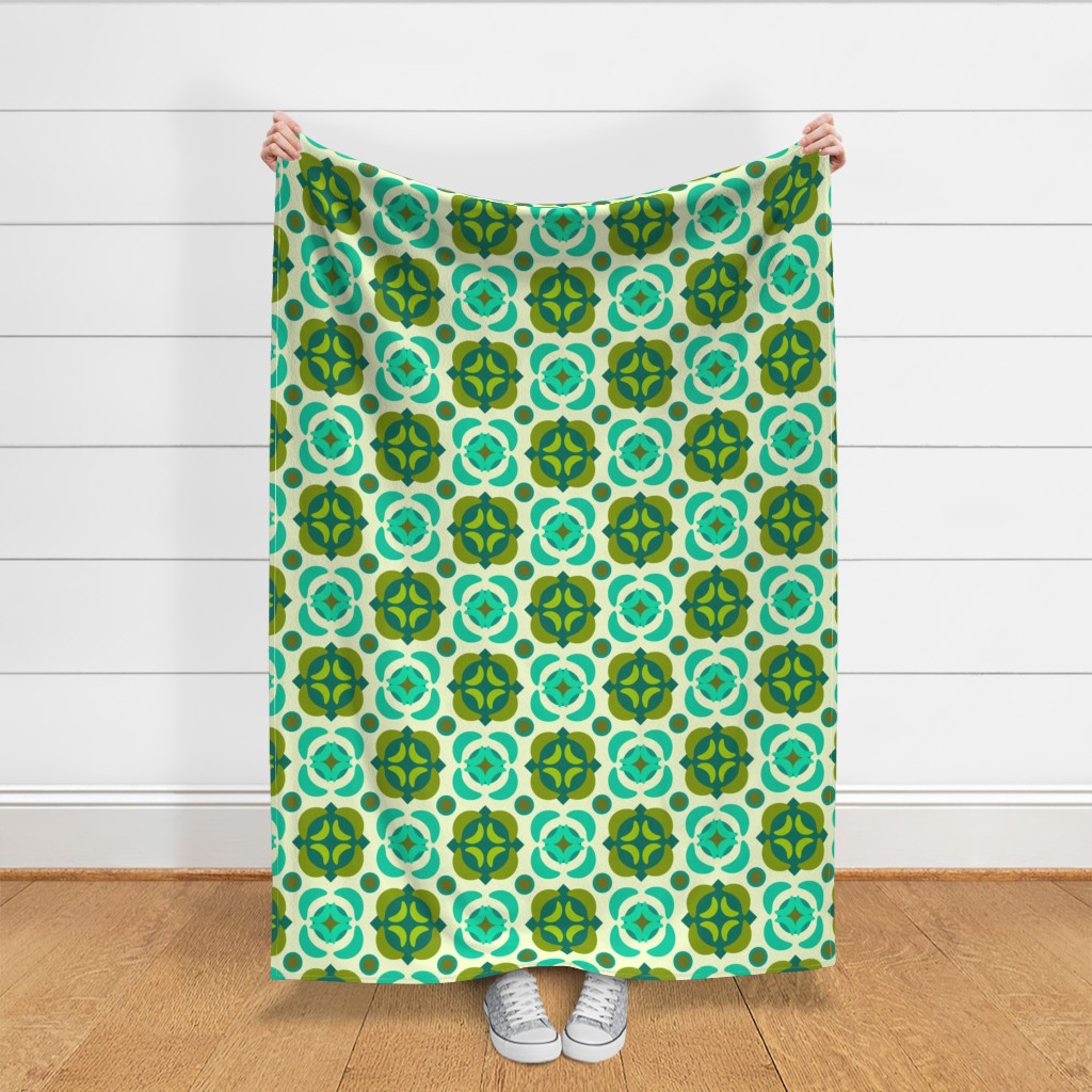 Throw blanket held up in front of a white shiplap wall