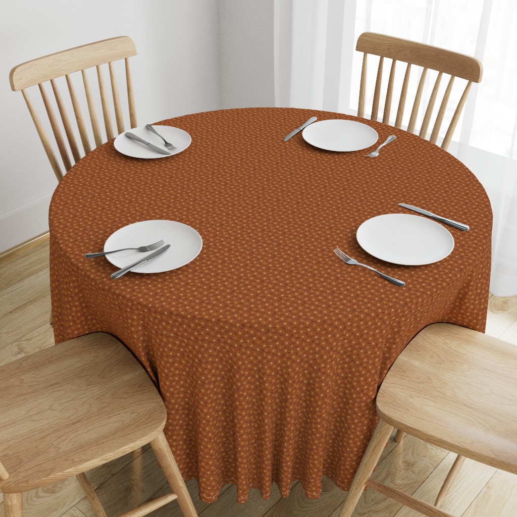 Top down angeled view of a wooden table with a 90 inch Round Tablecloth and four place settings arranged on top