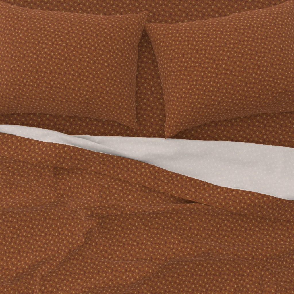 A close-up top down view of a bed with pillowcases and the top sheet pulled down slightly