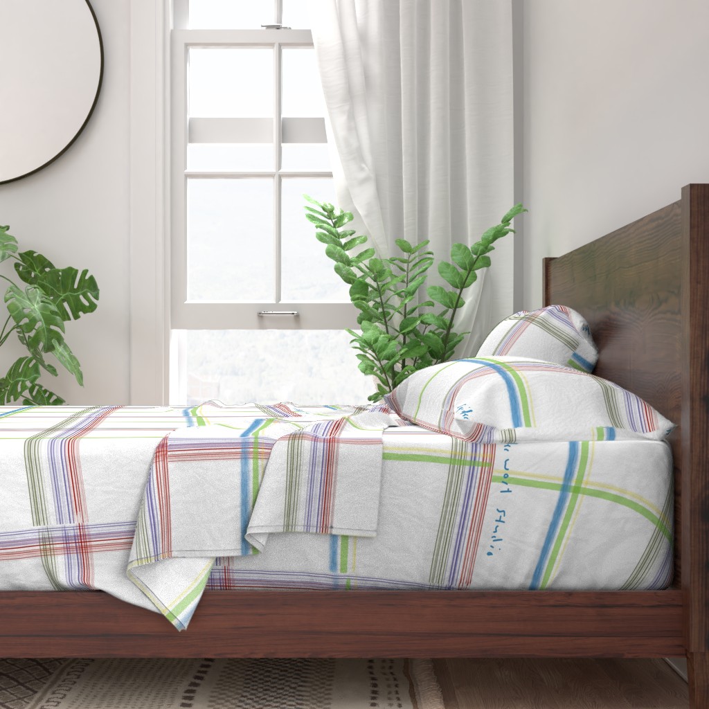 A neatly made bed with sheets and pillows with a wooden bedframe. The bed is next to a window with plants on either side and a round mirror hangs on the wall to the left of the window.