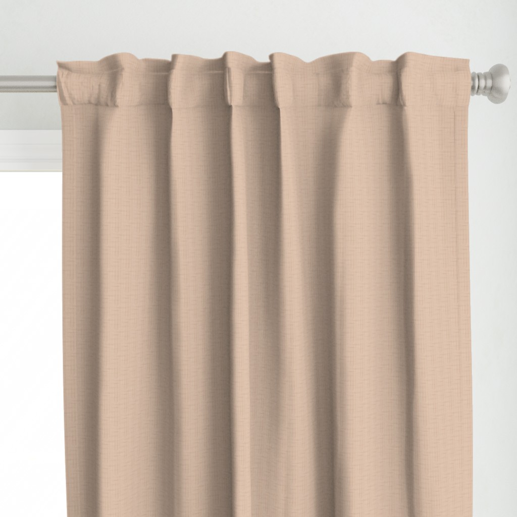 Close up of a Curtain panel hanging from a silver curtain rod in front of a window