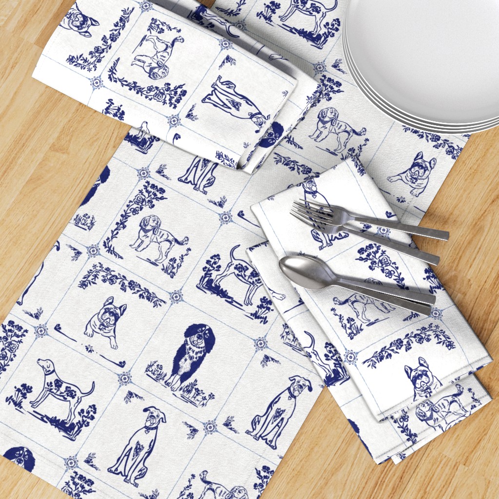 Top down table with a Table Runner placed diagonally with a set of Dinner Napkins, plates and silverware on top