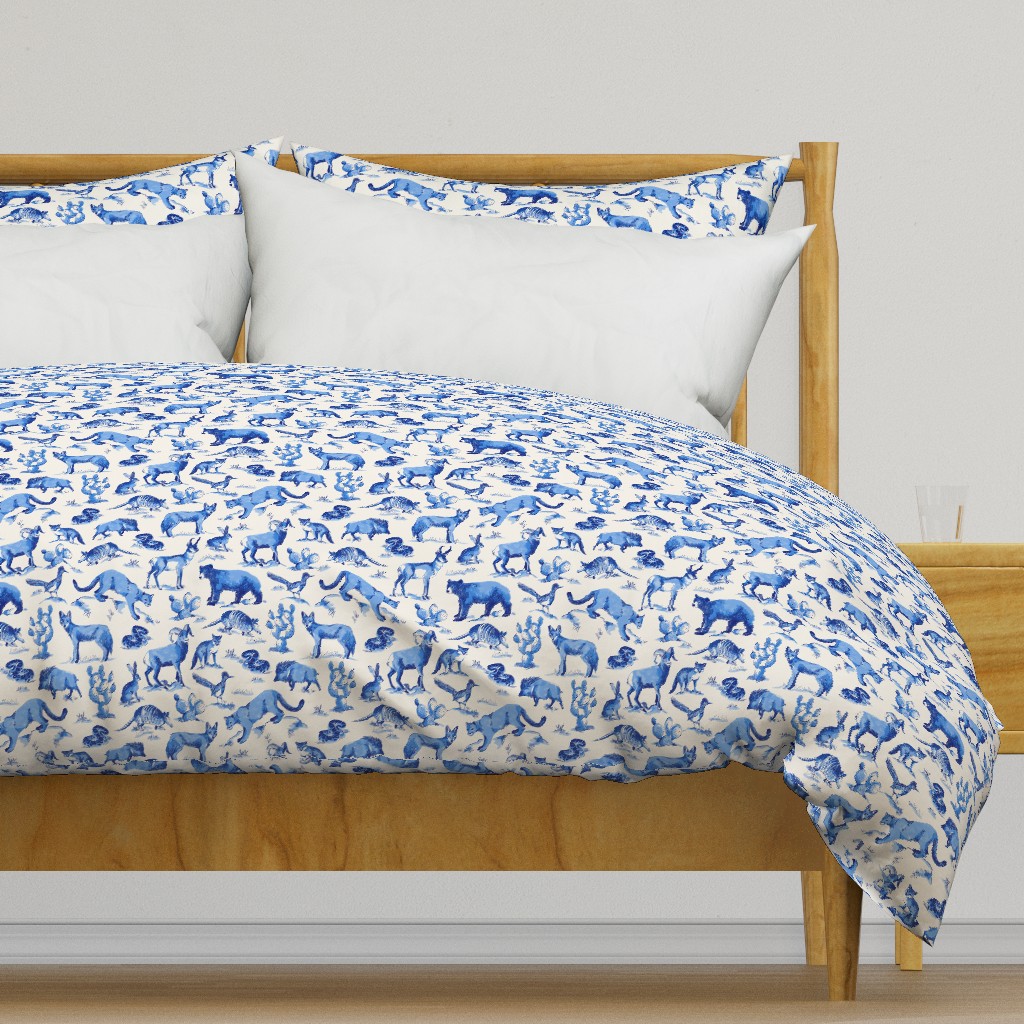 Light colored wooden bed frame with a duvet cover