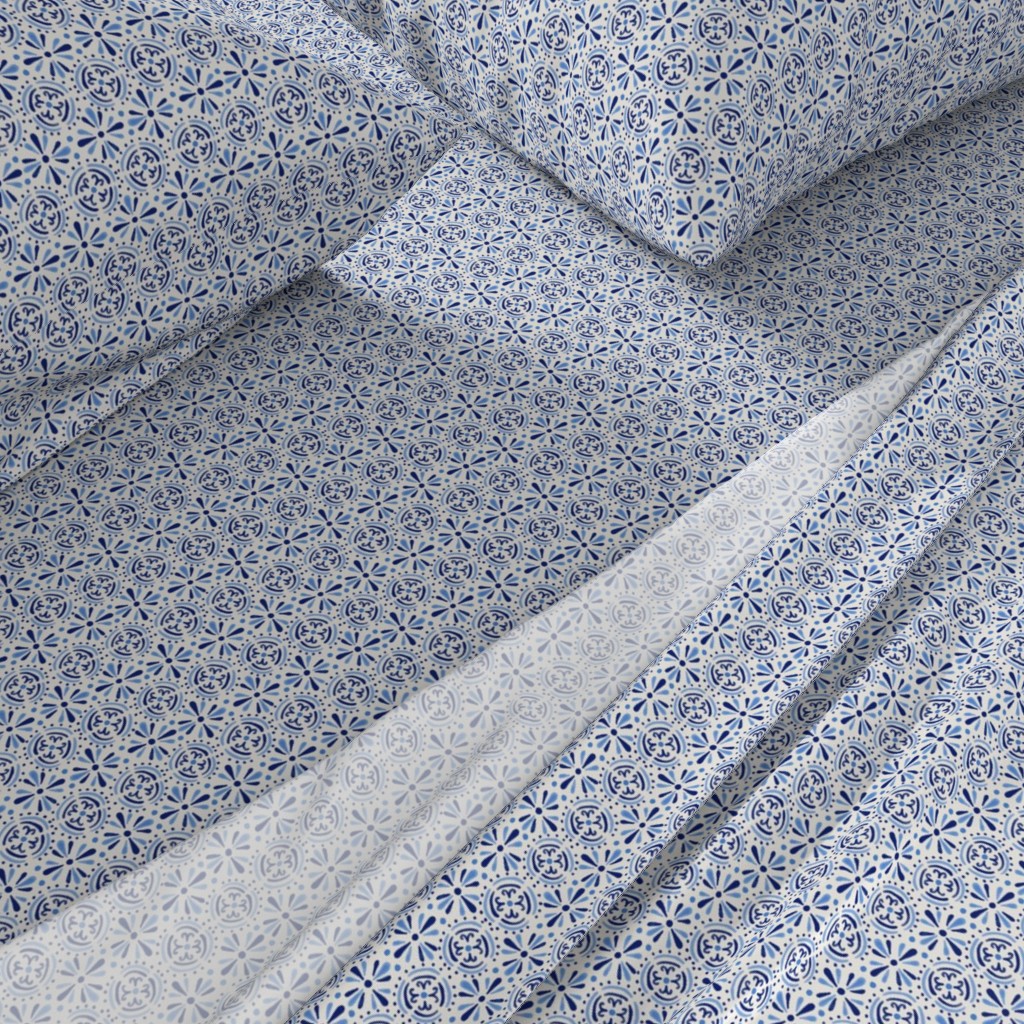 A close-up angled view of a bed with sheets and pillowcases