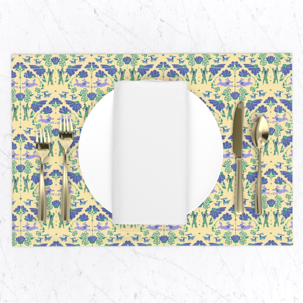 Top down of a table setting on a white marble table, a placemat with a plate and napkin and gold silverware set
