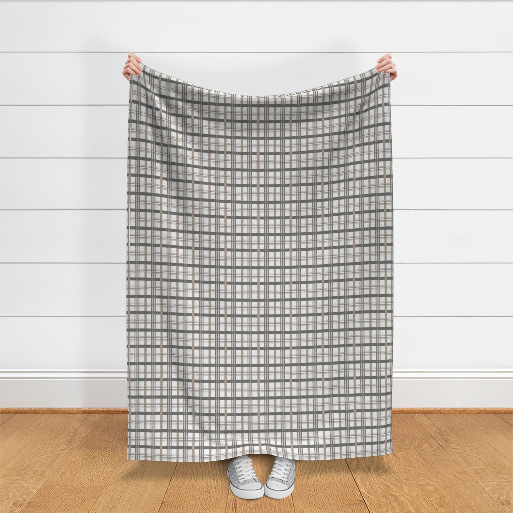 Throw blanket held up in front of a white shiplap wall