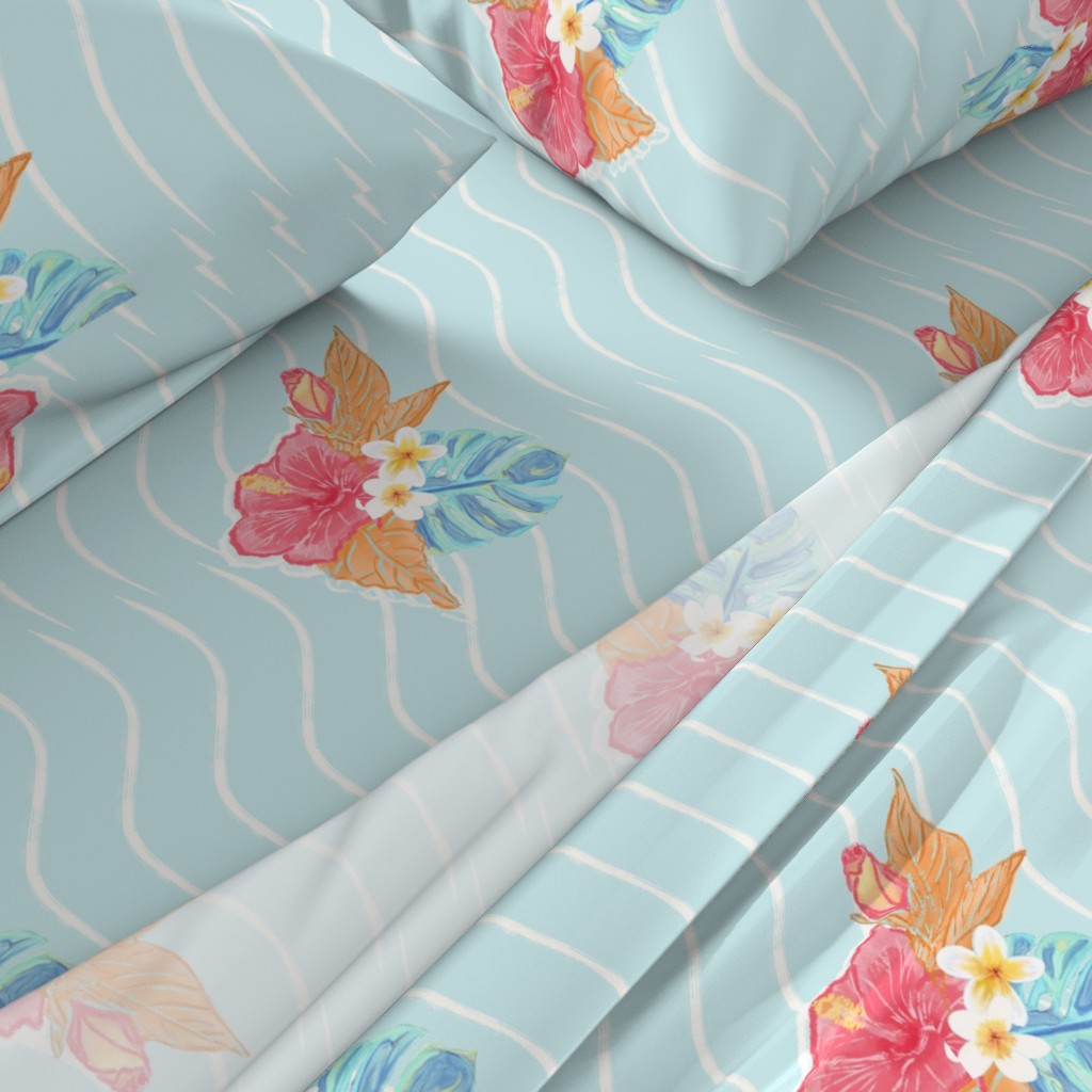 A close-up angled view of a bed with sheets and pillowcases