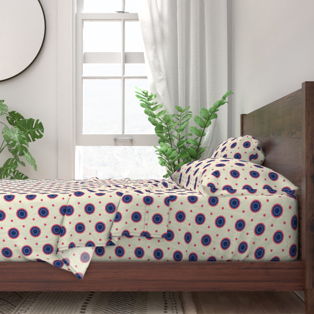 A neatly made bed with sheets and pillows with a wooden bedframe. The bed is next to a window with plants on either side and a round mirror hangs on the wall to the left of the window.