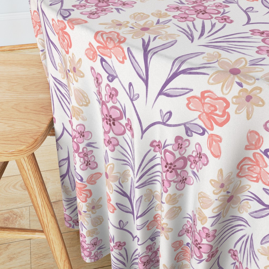 Angeled side view of a round table with wooden chair in the foreground and a 90 inch Tablecloth draped over the edge showing the sewn hem around the edge