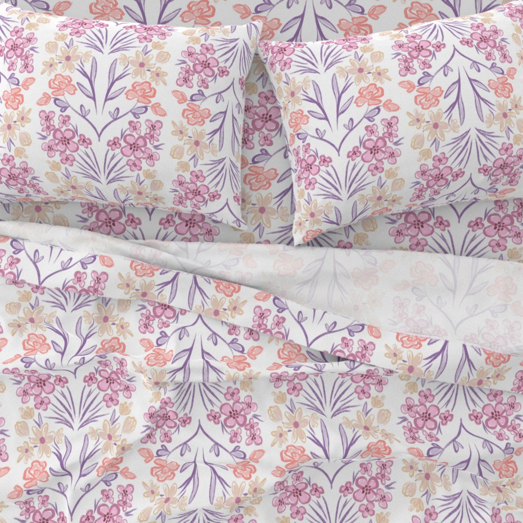 A close-up top down view of a bed with pillowcases and the top sheet pulled down slightly
