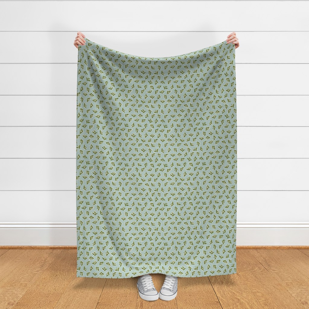 Throw blanket held up in front of a white shiplap wall