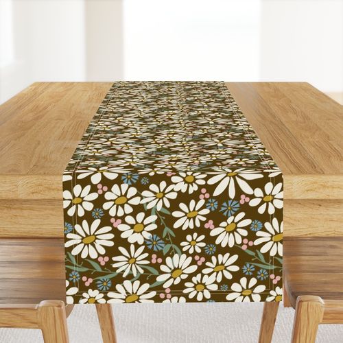 cream daisies with gold centers on a dark brown ground sage green leaves