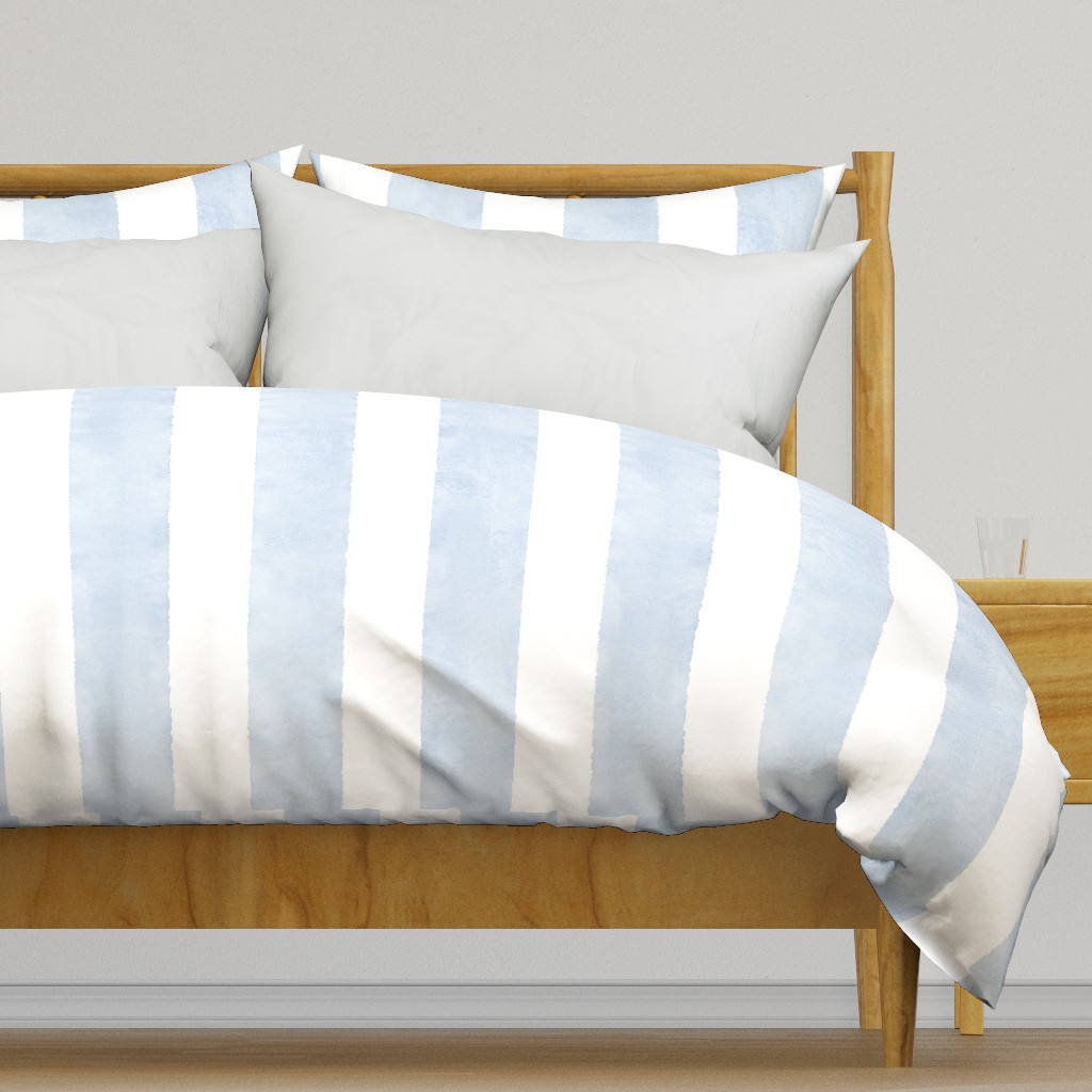 Light colored wooden bed frame with a duvet cover