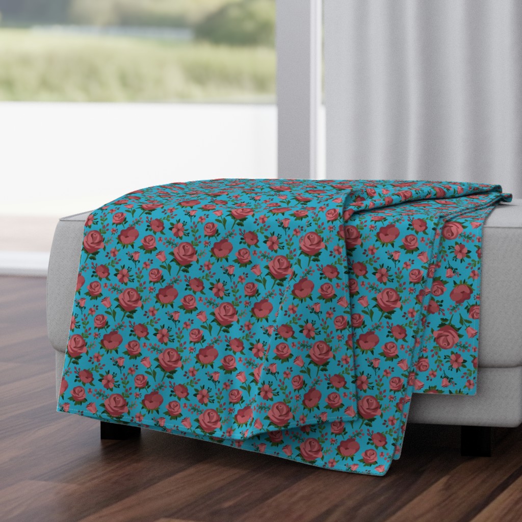Folded Throw Blanket draped over a plush fabric ottoman in a living room in front of an open window with dark wood floors.