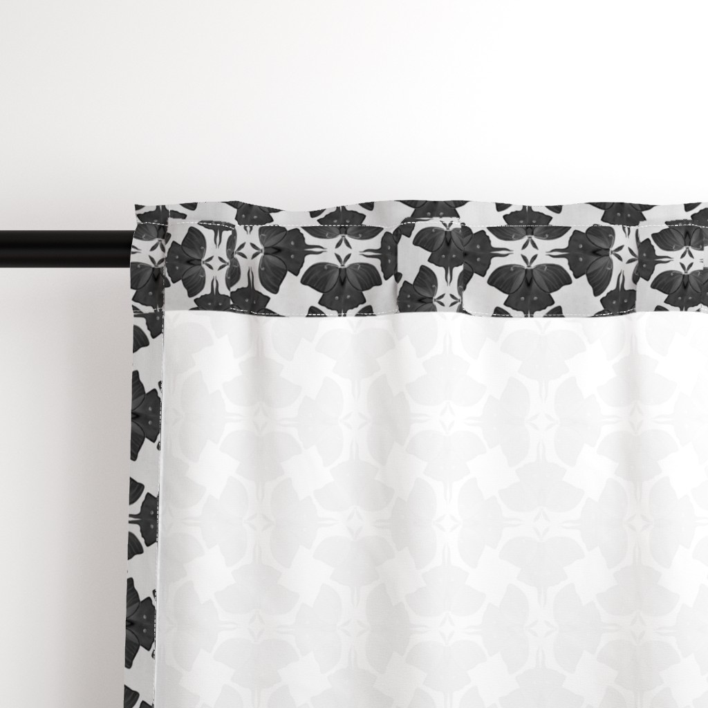 Close up of the back a Curtain panel hanging from a black curtain rod showing the rod pocket hanging option