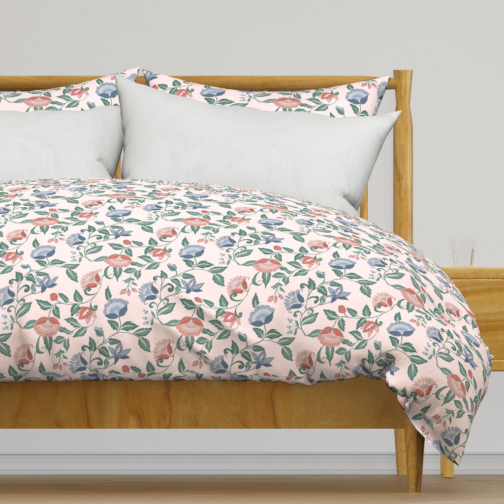 Light colored wooden bed frame with a duvet cover