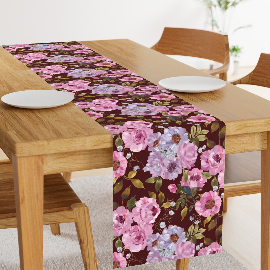 Angled light wood table with a 108 inch long Table Runner in the middle and two plates