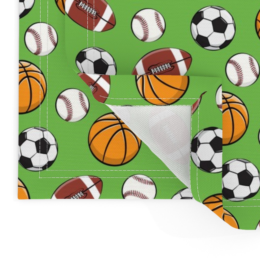 Close up of two Placemats stacked on top of eachother and the top left bottom corner is flipped up showing the hem and unprinted back