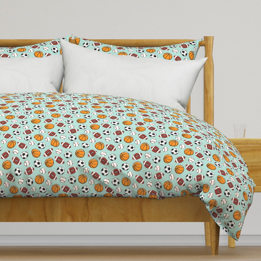 Light colored wooden bed frame with a duvet cover